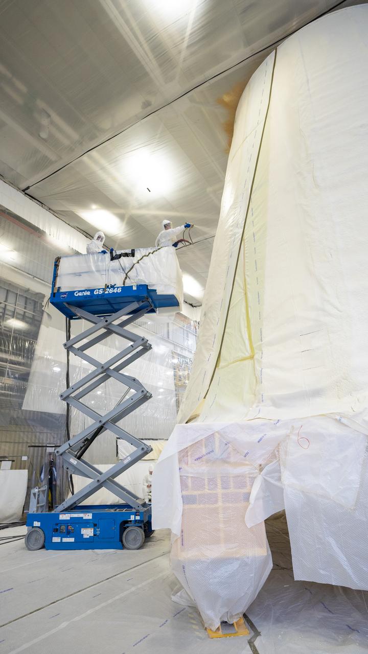 These photos show how technicians at NASA’s Marshall Space Flight Center in Huntsville, Alabama, have applied the thermal protection system material to the launch vehicle stage adapter (LVSA) of NASA’s SLS (Space Launch System) rocket for Artemis III, which will land astronauts on the Moon to advance long-term lunar exploration and scientific discovery and inspire the Artemis Generation. The LVSA is a cone-shaped element that connects the mega rocket’s core stage to its interim cryogenic propulsion stage (ICPS), partially enclosing it and protecting its avionics and electrical systems from the extreme pressures, sounds, and temperatures during launch and flight. Teams at Marshall began applying the thermal protection system material in the spring of 2023. Unlike other parts of the SLS rocket, the thermal protection system material for the LVSA is applied entirely by hand using a spray gun. During application, the technicians use a thin measuring rod to gauge the proper thickness. Once the thermal protection system has cured, certain areas are sanded down to meet parameters. The entire process takes several months.  The LVSA is fully manufactured at Marshall by NASA, lead contractor Teledyne Brown Engineering, and the Jacobs Space Group’s ESSCA contract. The LVSA for Artemis III is the last of its kind as future SLS rockets will transition to its next, more powerful Block 1B configuration beginning with Artemis IV. NASA is working to land the first woman and first person of color on the Moon under Artemis. SLS is part of NASA’s backbone for deep space exploration, along with the Orion spacecraft, advanced spacesuits and rovers, the Gateway in orbit around the Moon, and commercial human landing systems. SLS is the only rocket that can send Orion, astronauts, and supplies to the Moon in a single mission.
